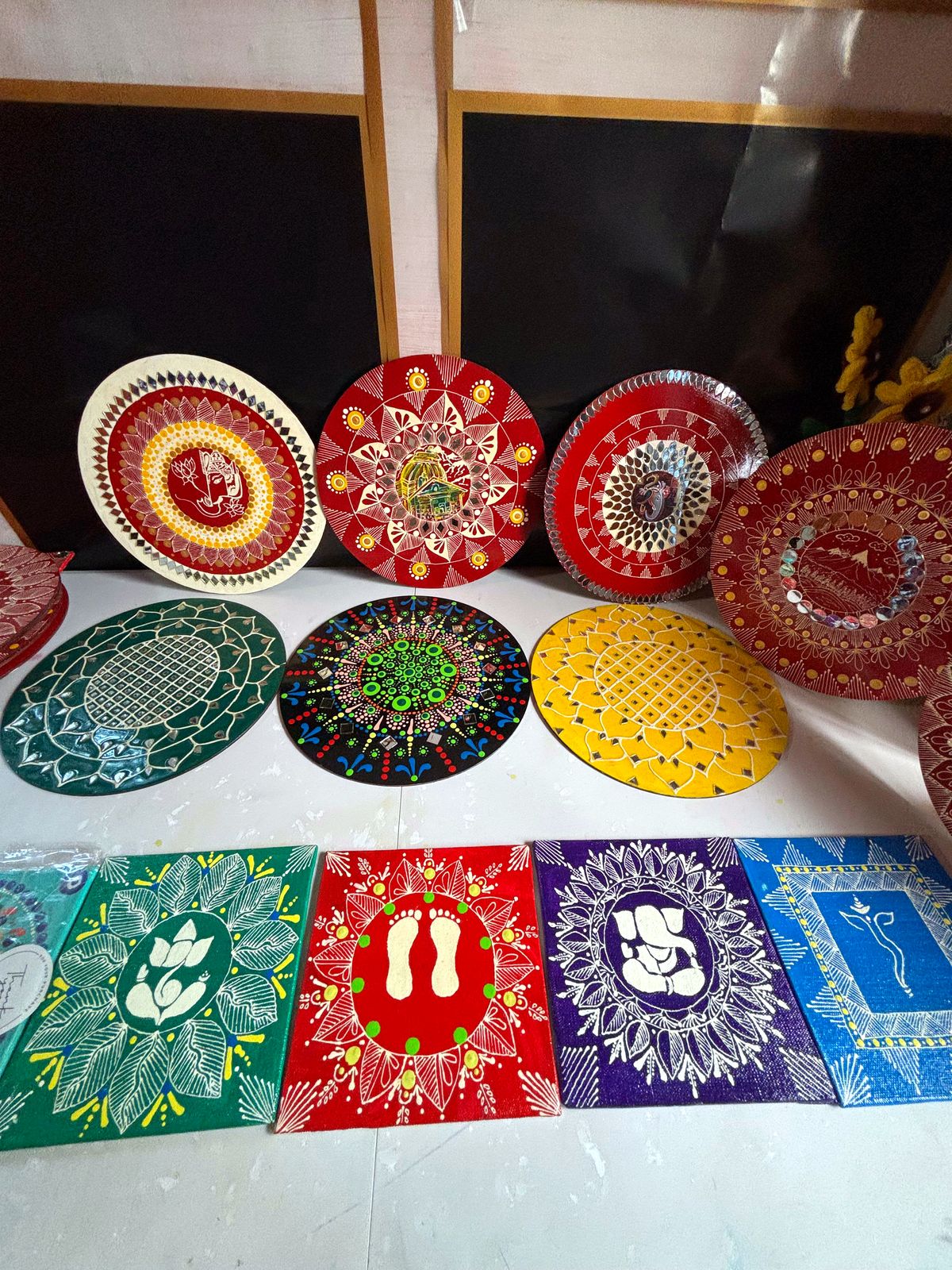 Colorful Aipan mandala plates and canvas panels